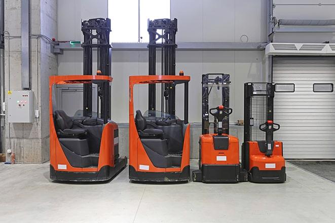 a forklift carrying pallets of boxes in a distribution center